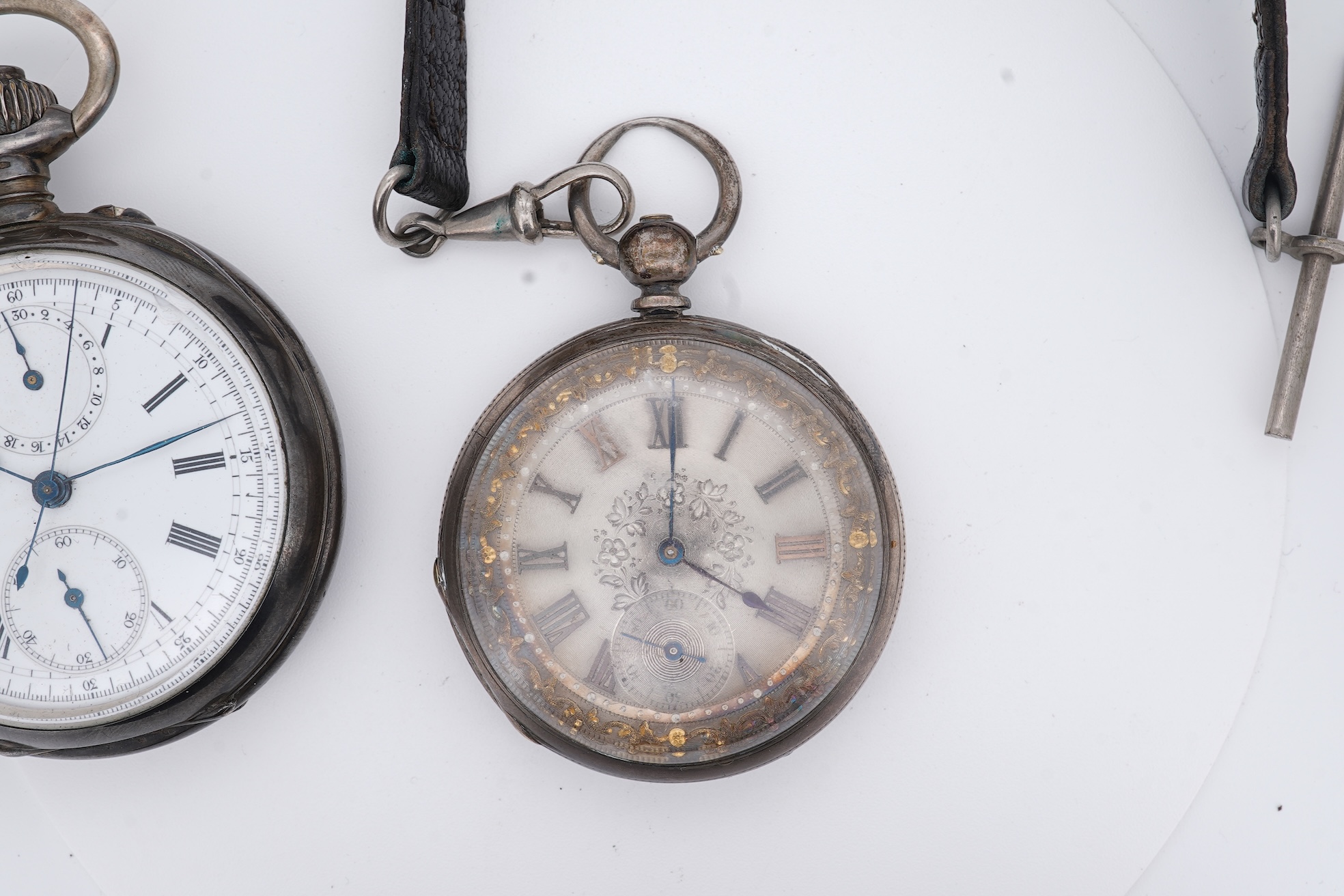 An early 20th century continental 800 standard white metal open faced chronograph pocket watch, with Roman numerals and two subsidiary dials, case diameter 50mm, together with a similar smaller white metal open faced poc